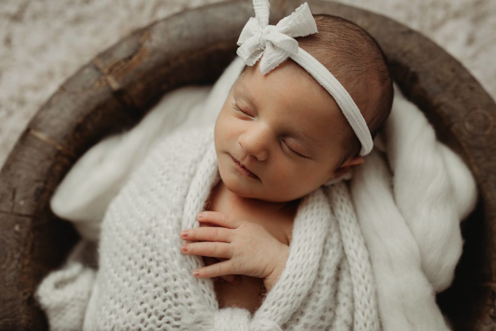 Newborn photograph of baby girl in prop by a Janesville, WI photographer
