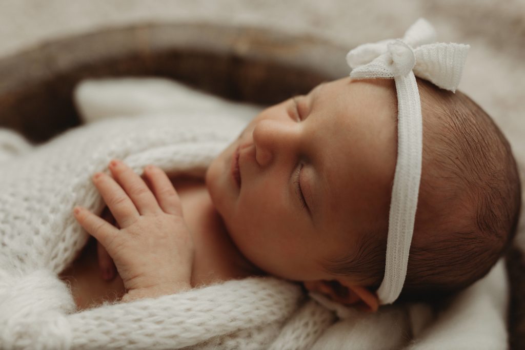 Newborn photograph of baby girl in prop by Olivia Acton Photography who is a Janesville, WI Newborn photographer. 