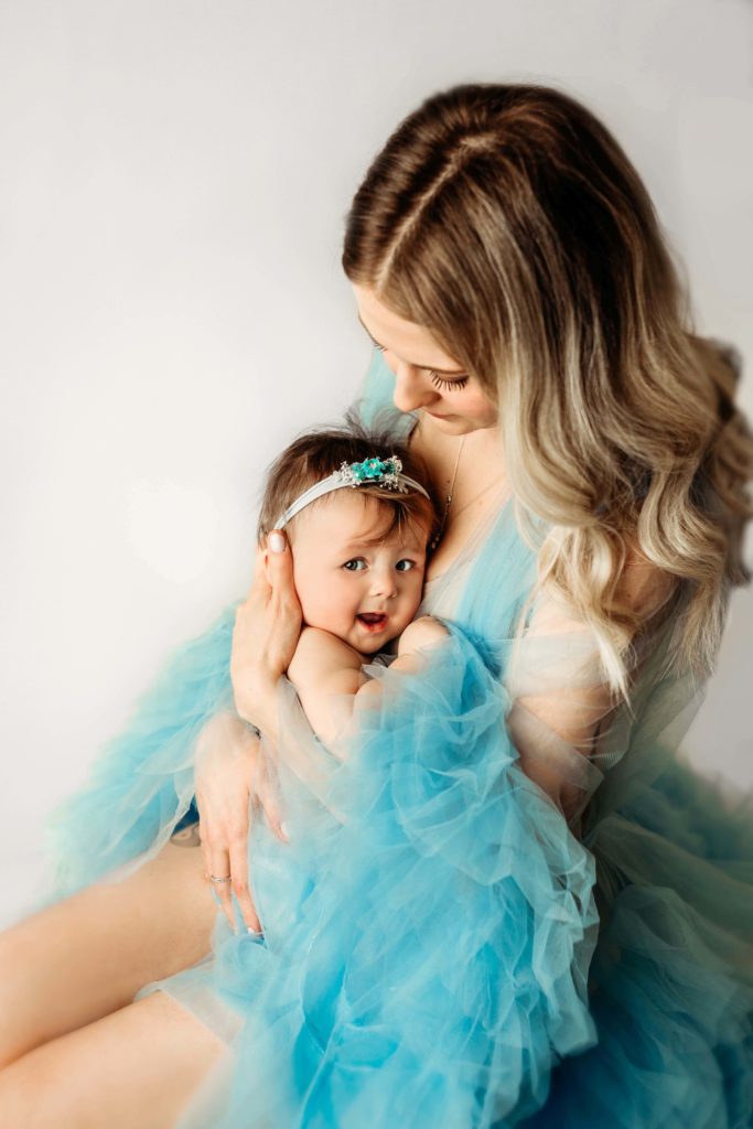 Baby and mom photograph in blue dress by Olivia Acton Photography