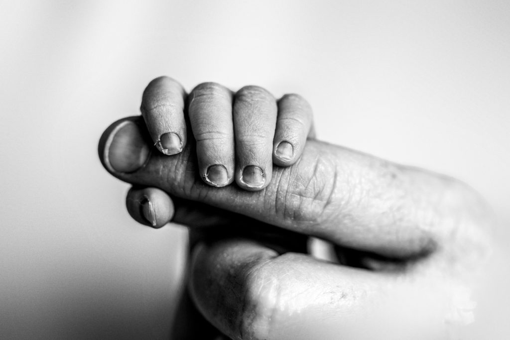 Baby hand grabbing finger by Olivia Acton Photography