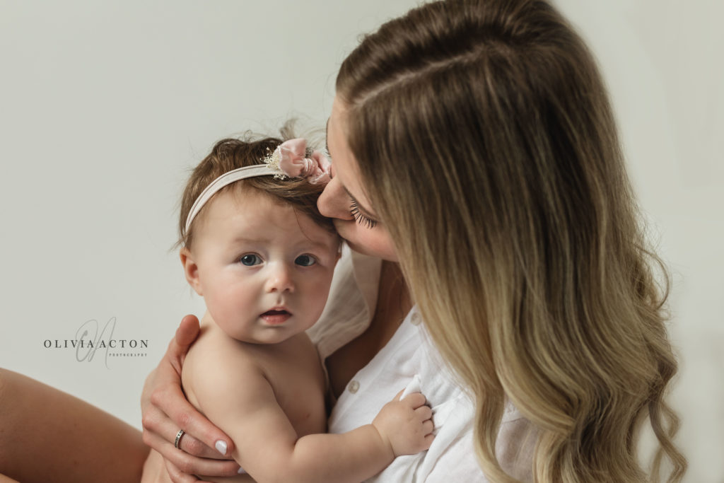 Mom and baby in white in studio by Olivia Acton Photography in Janesville, WI