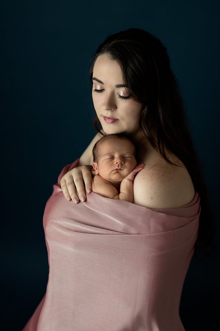 Baby cuddling with mom during newborn session in Janesville, WI by Olivia Acton Photography