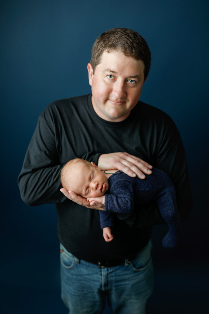 baby boy with dad in studio with blue background by Olivia Acton Photography