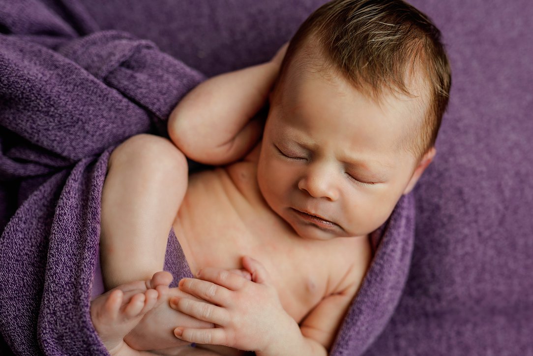Newborn girl in purple in Janesville, WI