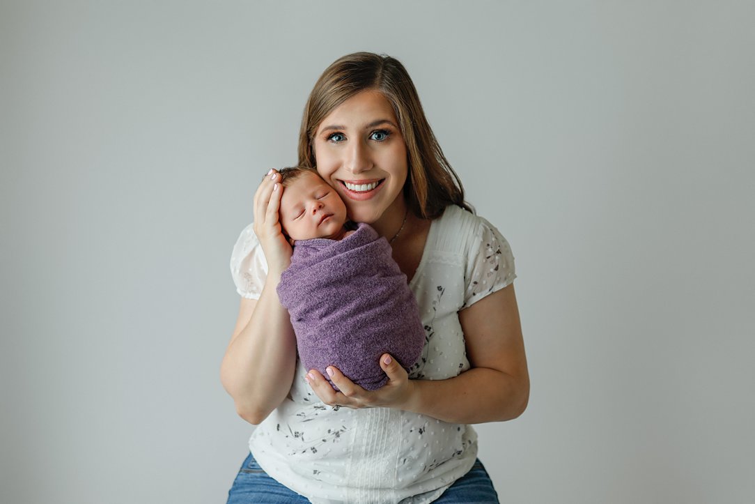Baby cuddling with mom during newborn session in Janesville, WI by Olivia Acton Photography