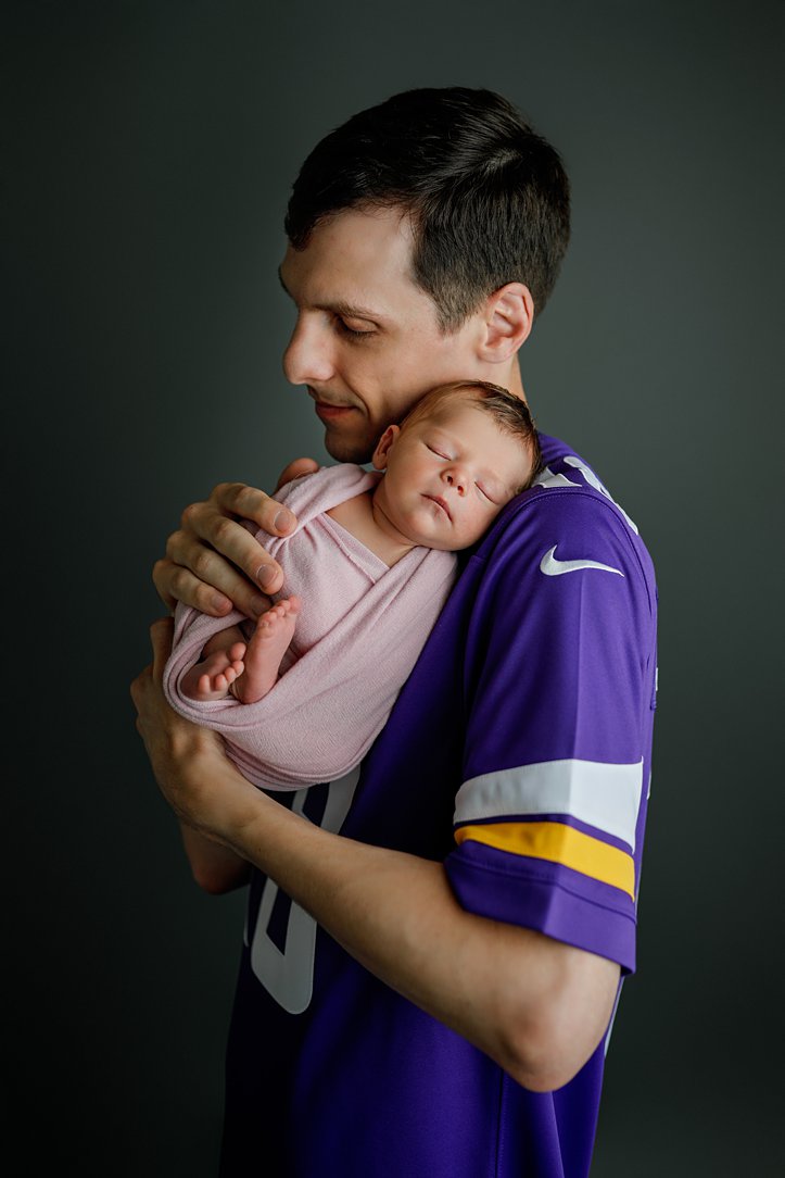 Baby and dad in studio during newborn session by Olivia Acton Photography