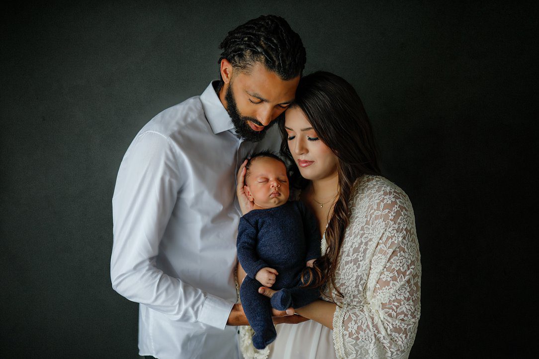 New mom and dad holding baby boy during newborn session in Janesville, WI