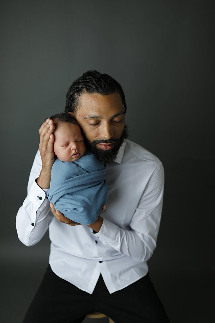 Dad and baby boy in blue by Olivia Acton Photography during newborn photoshoot