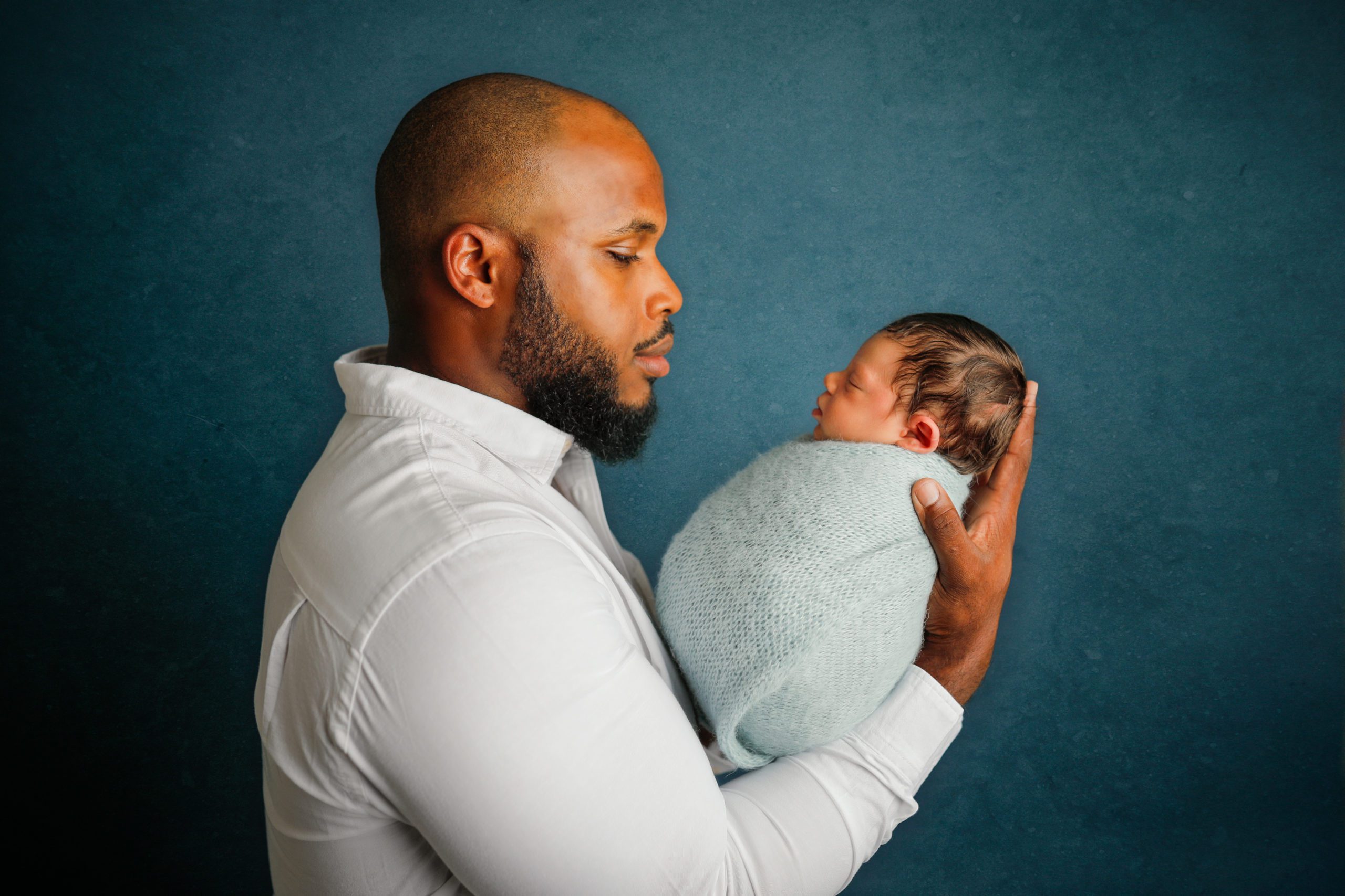 newborn boy with dad in blue at newborn session by Olivia Acton Photography