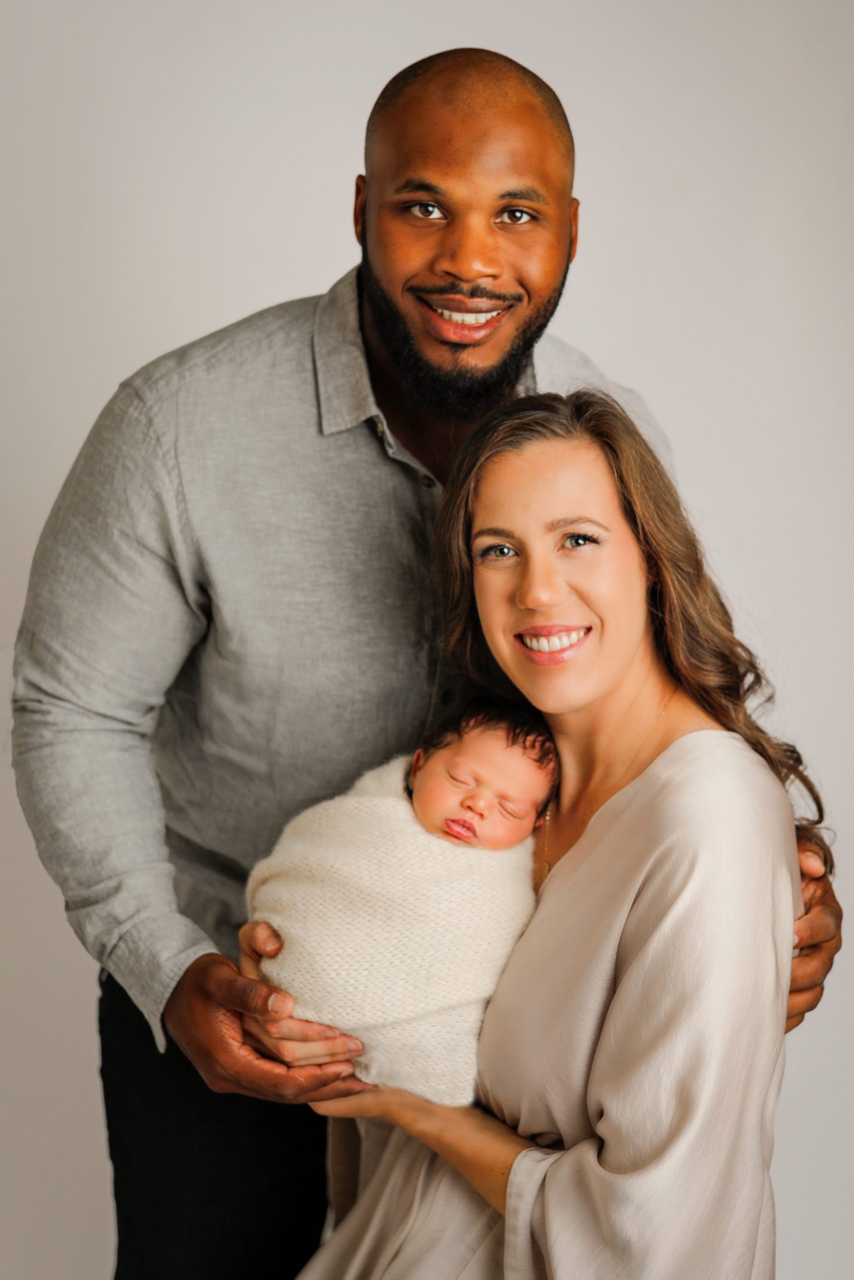 Baby with family during newborn session in Janesville, WI 