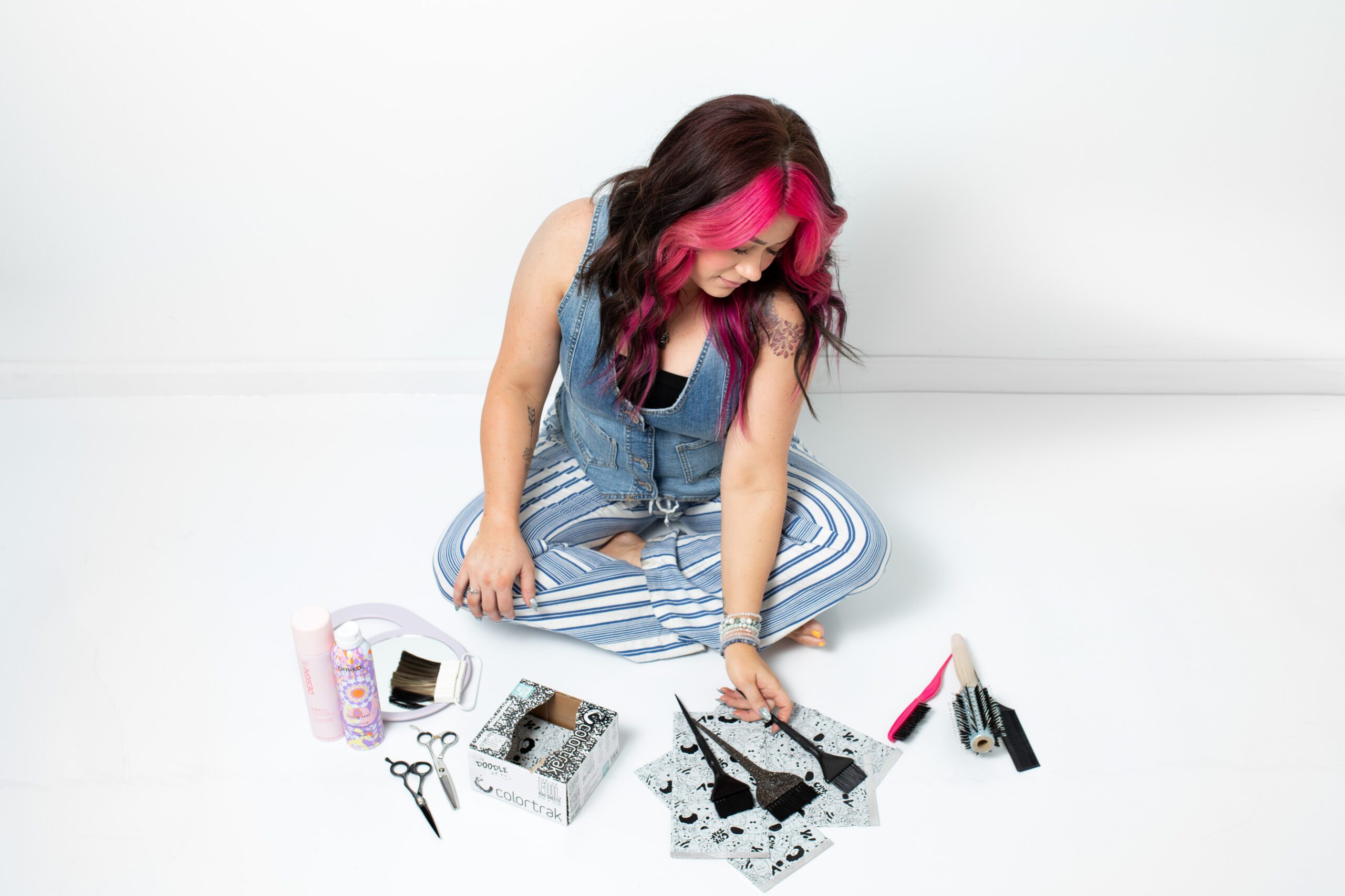 Hair stylist photoshoot, Sitting with hair styling tools, white background